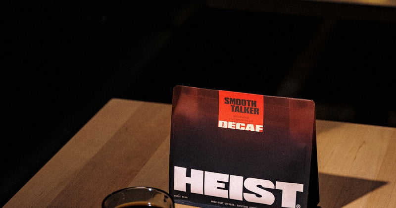 A quiet dark room at night with a single cup of coffee, caffeine and sleep