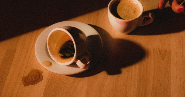 Hands holding a warm cup of black decaf coffee, easy on the stomach