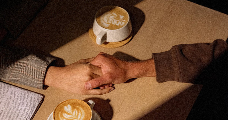 A smooth cup of low acid Heist decaf coffee in warm amber light