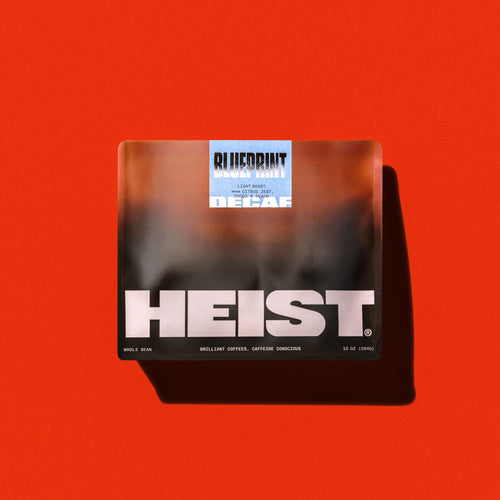 Top-down view of Heist decaf coffee bag showcasing front label on white background