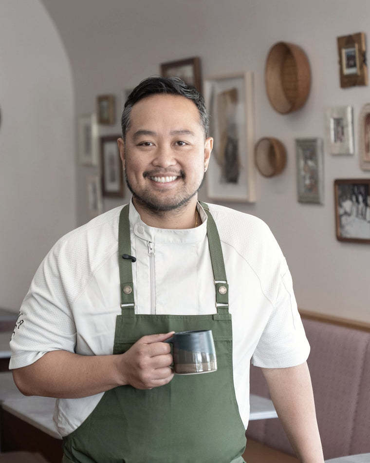 Chef Lordfer Lalicon holding a coffee mug in a dining room